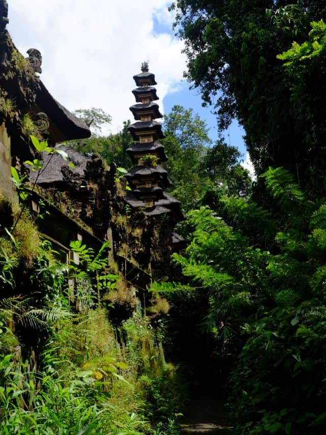 Balinese temple tower surrounded by jungle near Campuhan Ridge Walk Ubud