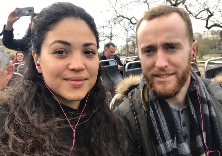 Close up of Abi and Jack on the top deck of a Big Bus Tour in Paris in Winter