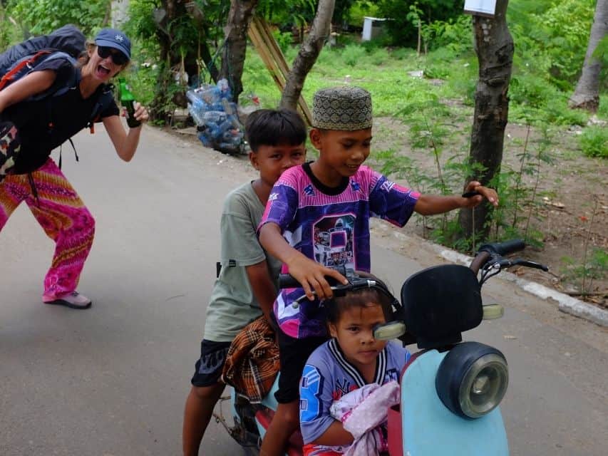 Three children on an e-scooter in Gili Meno, Lombok