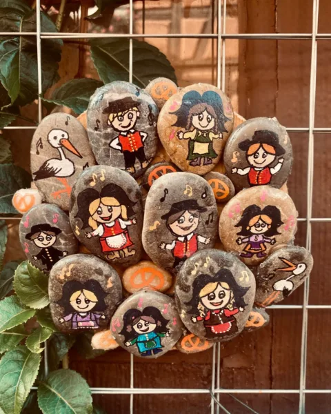 painted pebbles hung on a wall on the streets of Eguisheim