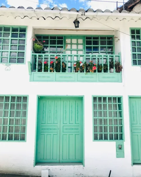 the white-washed and green walls of buildings in El Cocuy town, Colombia