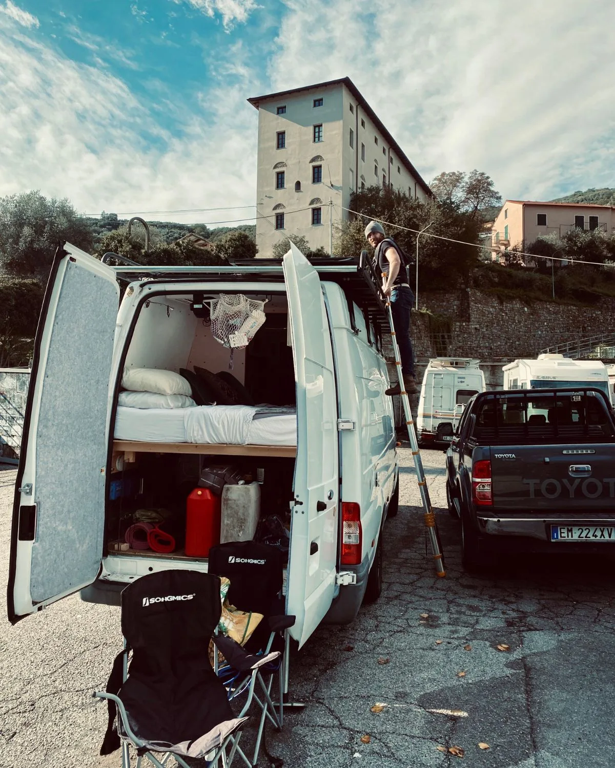 Jack cleaning the leaves from our campervan in Italy.
