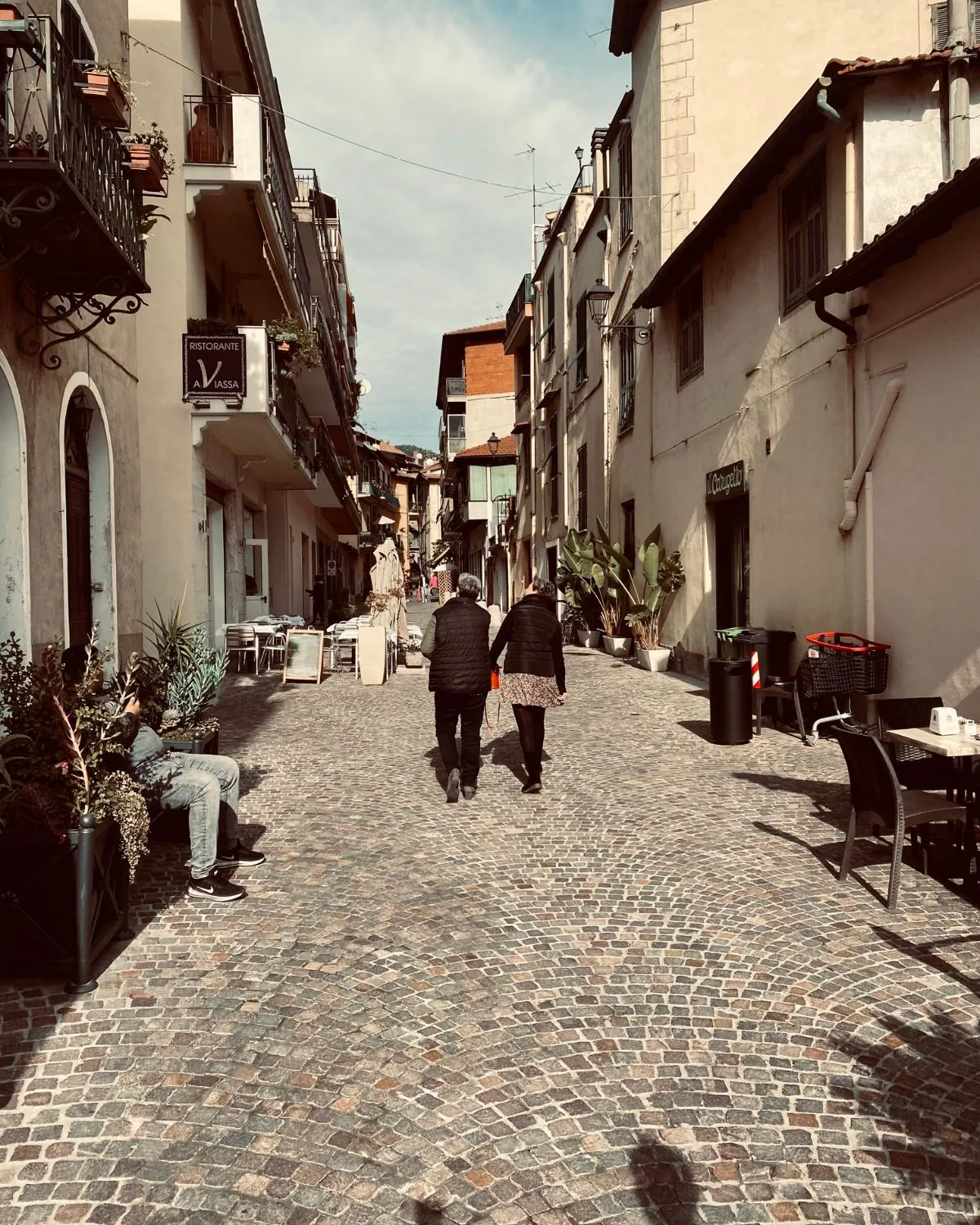 Couple holding hands in Il Borgo, Dolceacqua, Italy.