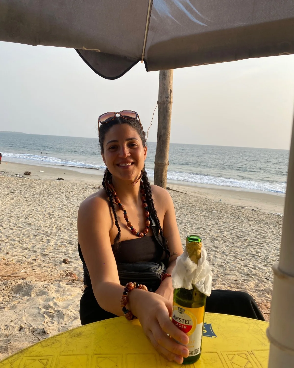 Abi on Lumley beach drinking a beer at sun down