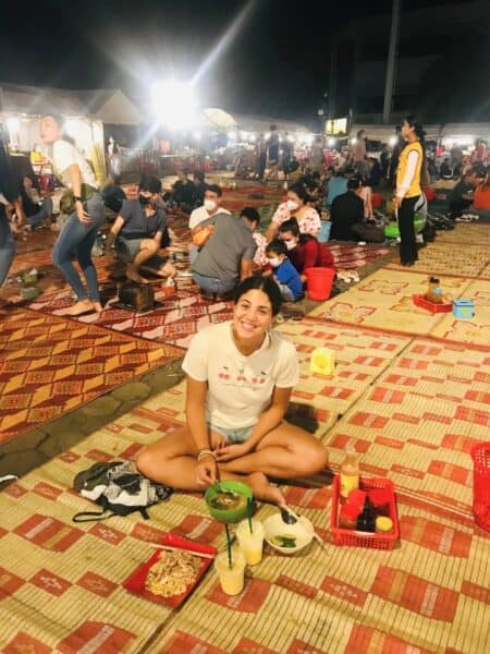 Abi alone in a food market in Cambodia