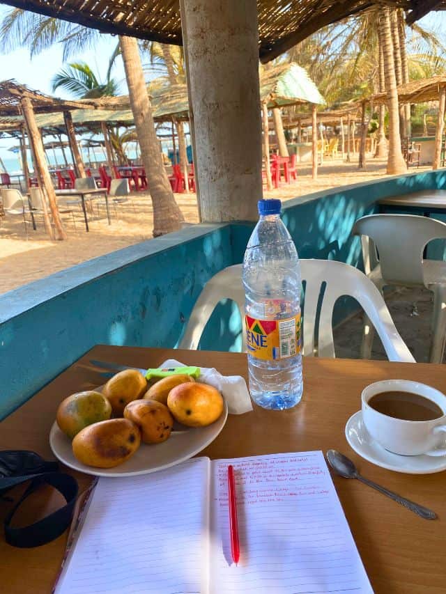 Notebook, water and mango in The Gambia