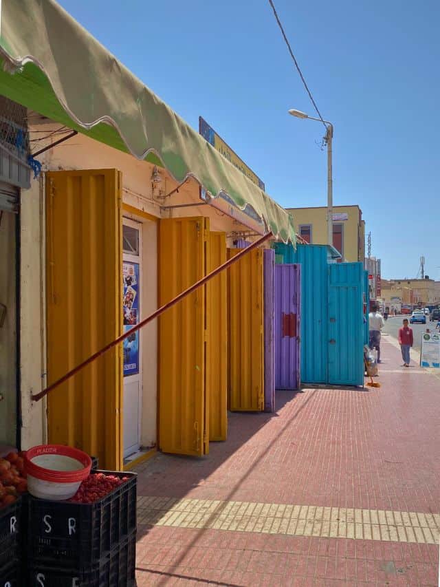 Colourful street in Morocco with brightly painted shutters.