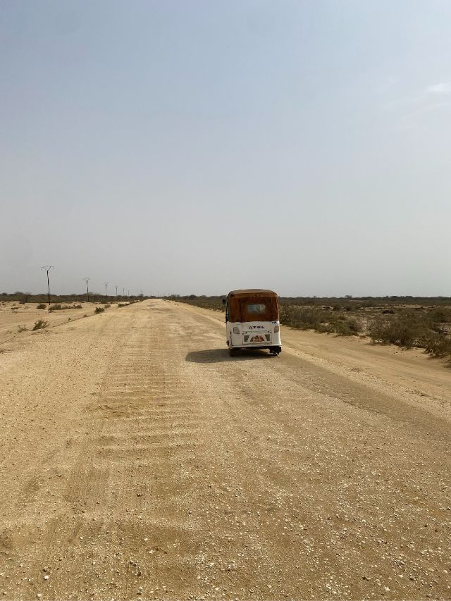 A lone tuk-tuk on the arid landscape of Senegal.