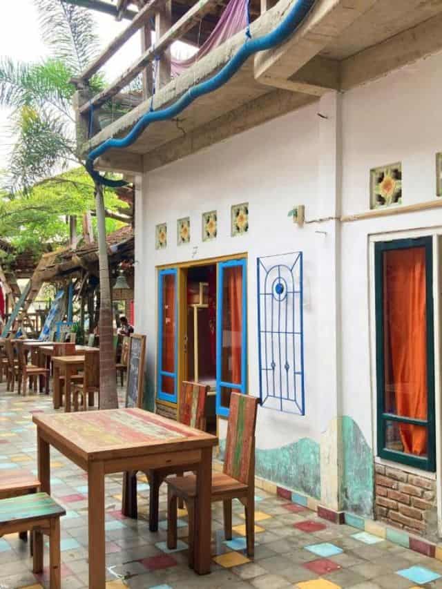 Colourful courtyard seating area at La Boheme Bajo Hostel in Labuan Bajo
