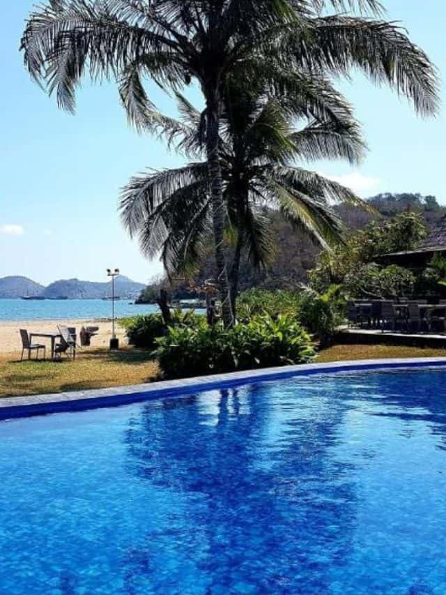 Swimming pool and beachfront setting at Luwansa Beach Resort, Labuan Bajo