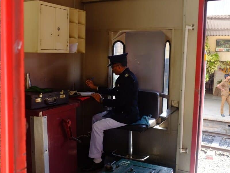 Ticket inspector seated inside the train carriage in Sri Lanka