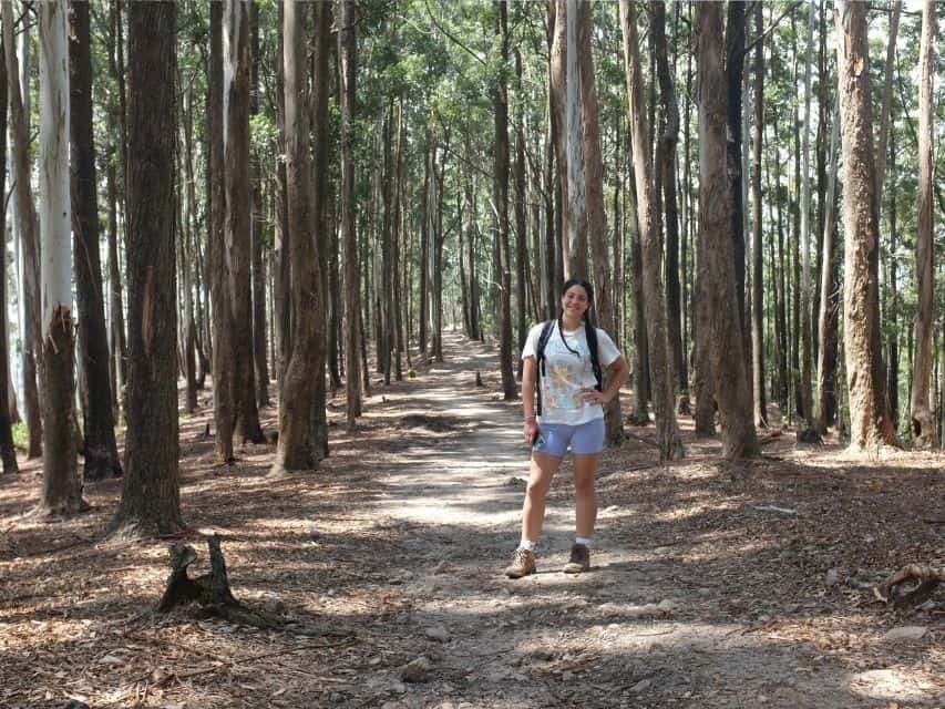 Woman standing on a forest trail near Ella, Sri Lanka