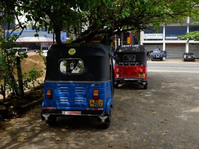 Two tuk-tuks parked in the shade in Sri Lanka, useful for short local transfers and station-to-bus connections.