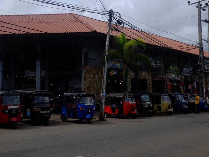 Ahangama travel tips: tuk-tuks parked along the busy main road in town.