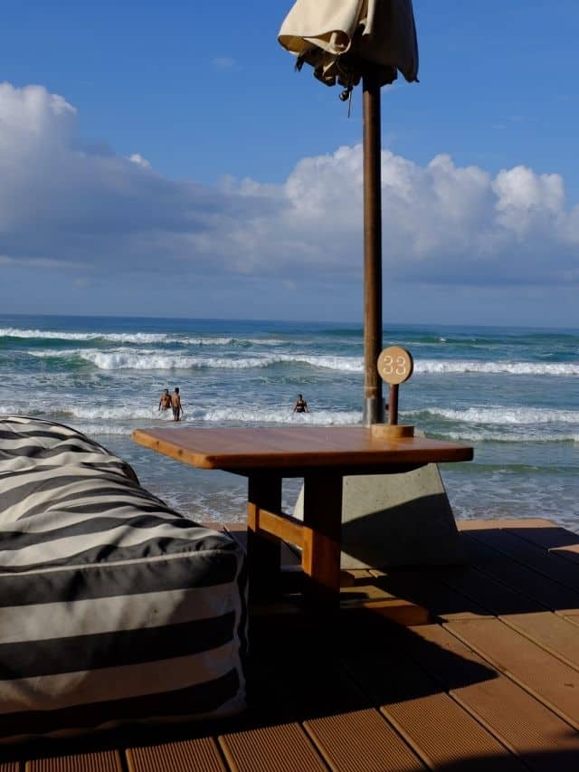 Striped beach lounger beside the ocean at a café in Ahangama