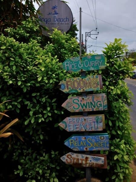Colourful beach signpost near Ahangama with rooms and swing signs