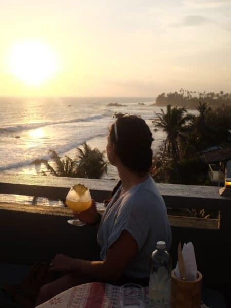 Woman enjoying sunset drinks at Lighthouse Ahangama rooftop bar