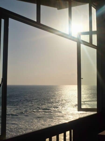 Ocean view through an open window at a coastal hotel in Ahangama