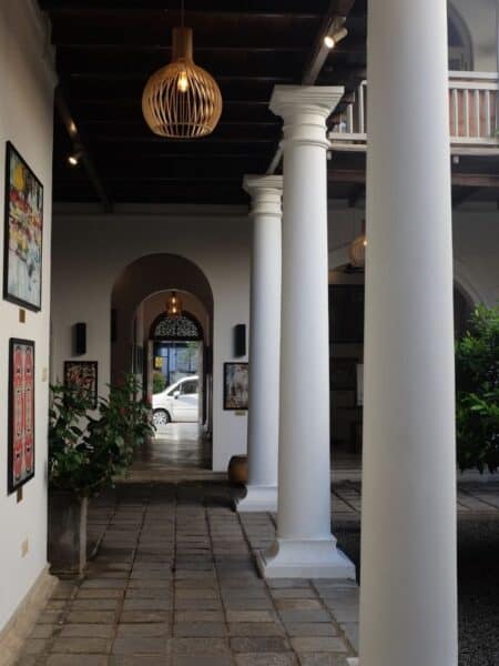 Colonial-style courtyard with white pillars and artwork during a Galle Fort day trip from Ahangama