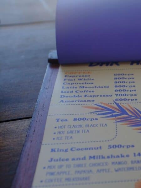 Close-up of a drinks menu showing coffee prices in Sri Lankan rupees.