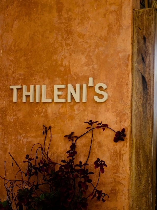 Terracotta wall with the Thileni’s sign outside a beachfront café in Ahangama.