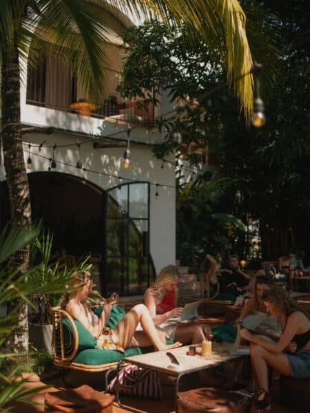 Travellers working on laptops at a leafy cafe in Ahangama.