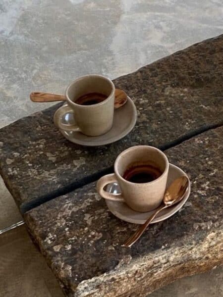Two small coffees on a stone table at one of the cafes in Ahangama.