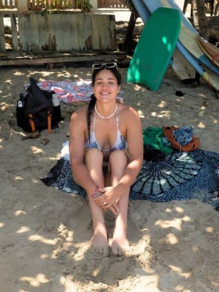 Traveller sitting on the sand at Hiriketiya Beach, a popular south coast day trip from Ahangama