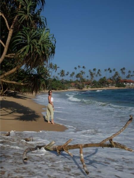 Hiriketiya Beach with soft waves, palm trees and golden sand on Sri Lanka’s south coast.