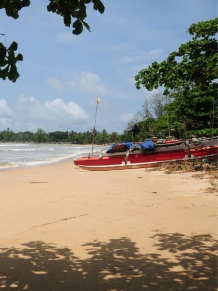 Fishing boat pulled onto the sand at a quiet beach on Sri Lanka’s south coast.