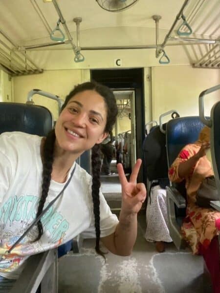 Traveller smiling inside a Sri Lankan train carriage during a budget trip around the island.