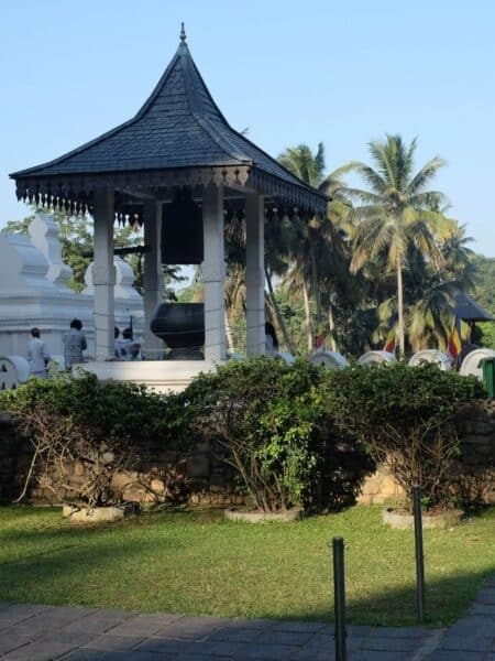 Temple bell tower and palm trees at the Temple of the Tooth in Kandy, a classic stop on a Sri Lanka 5 days itinerary.