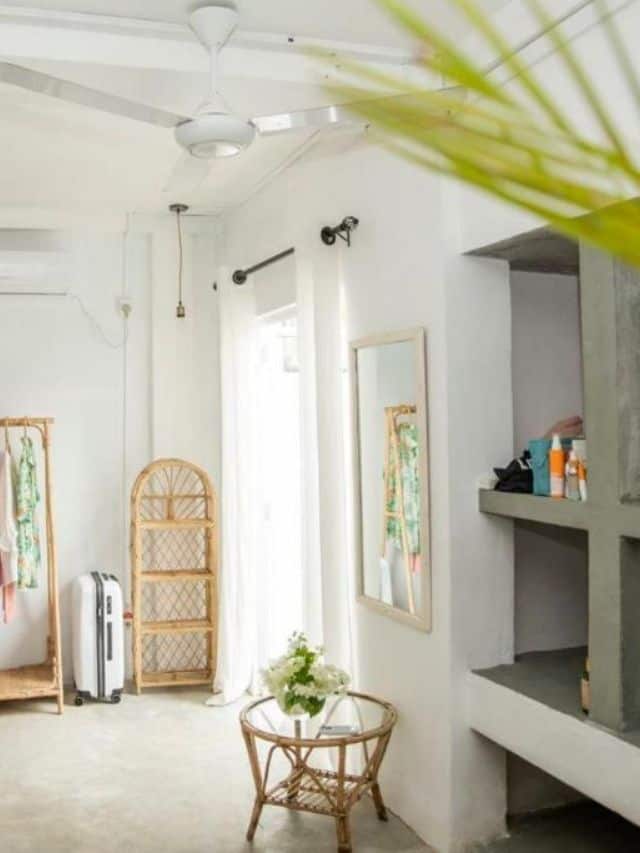 Bright room with storage shelves, mirror and tropical decor at 7BD Surf House.