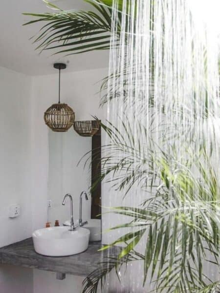 Open-roof bathroom with tropical plants at 7BD Surf House in Ahangama.