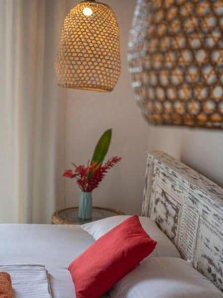 Boho double room detail with rattan lamp and white bedding at Seven Black Diamonds Ahangama.