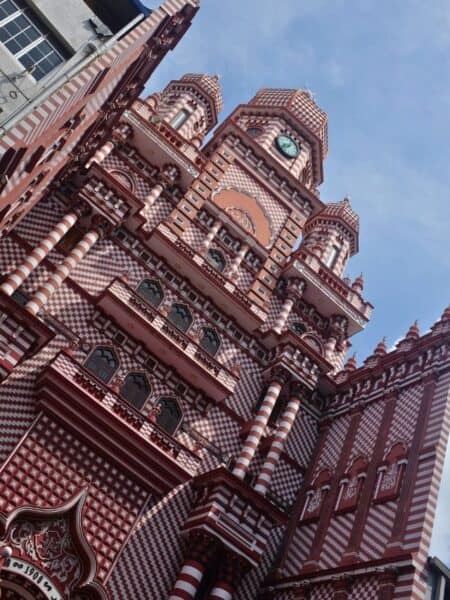 Red and white exterior of Jami Ul-Alfar Mosque in Colombo