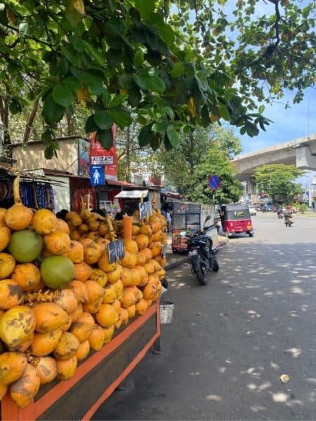 Coconut stand and tuk-tuk on a busy Colombo street during my Colombo City Tour by Tuk Tuk