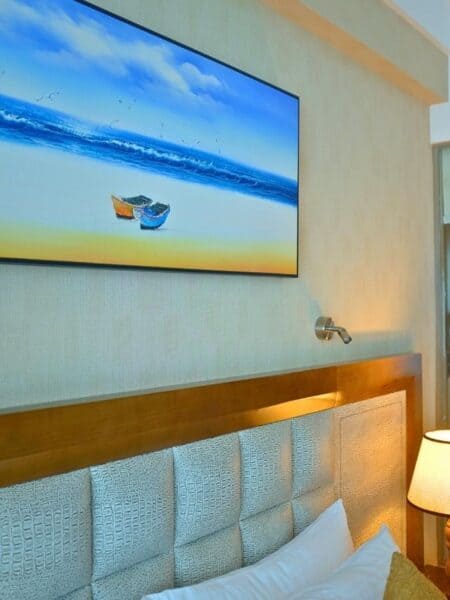 Decorative coastal artwork above the bed in a modern Colombo hotel room.