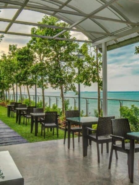 Outdoor rooftop seating area with ocean views at a Colombo hotel.
