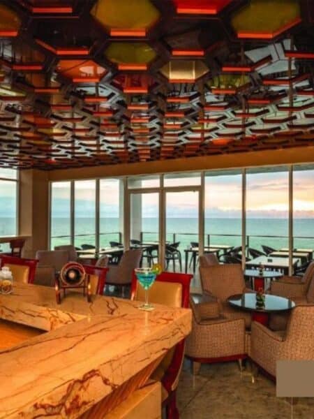 Rooftop bar and restaurant at Marino Beach Colombo with sea views through large windows.