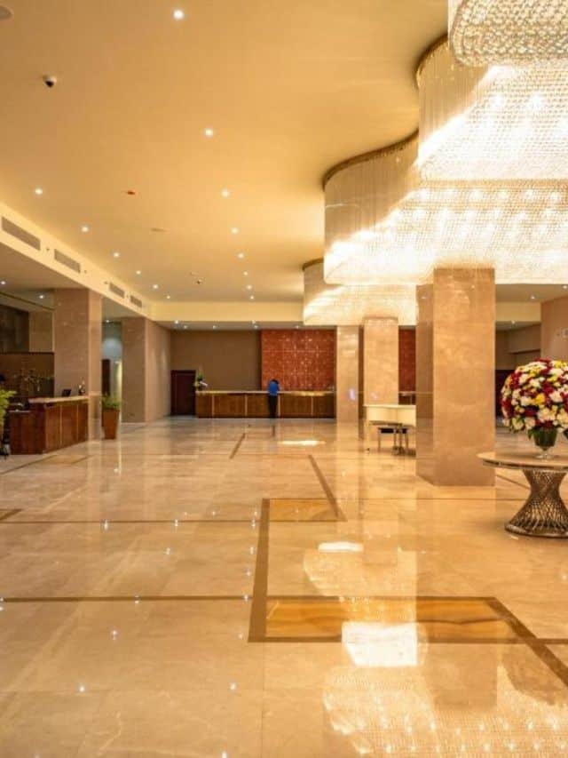 Spacious Marino Beach Colombo lobby with marble floors, reception desks and chandeliers.
