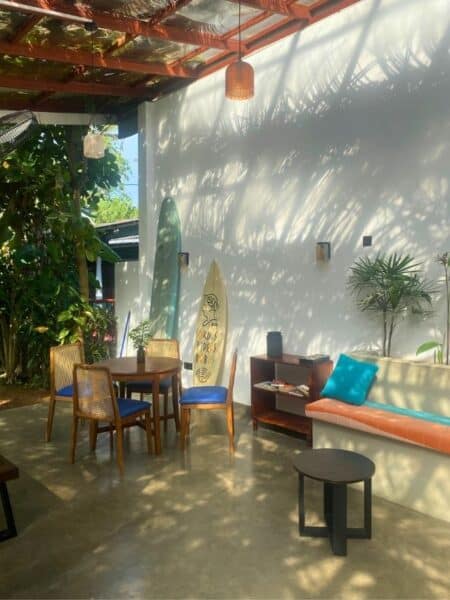Communal lounge area with surfboards and soft morning light at Mellow Hostel in Sri Lanka.