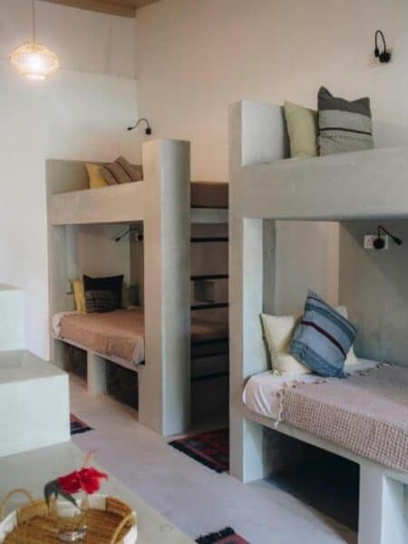 Dorm room with concrete bunk beds at Mellow Hostel in Sri Lanka.