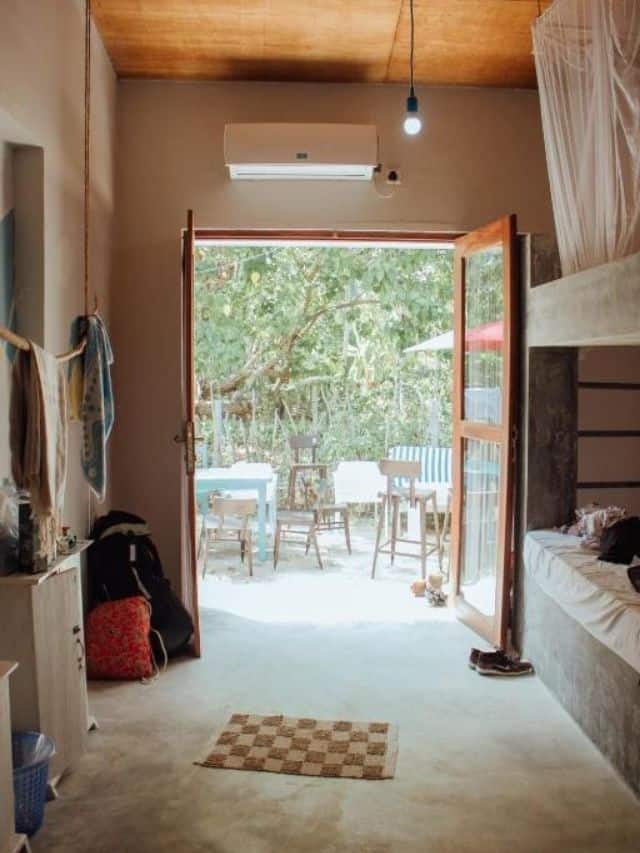 Shared dorm room opening onto outdoor seating at Mellow Hostel.