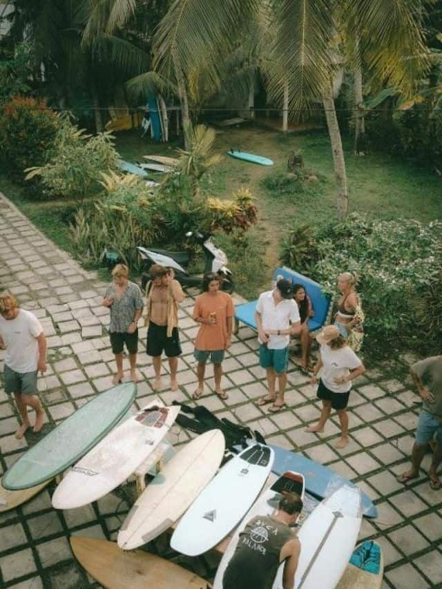 Travellers with surfboards during a group activity at Mellow Hostel near Kabalana Beach.