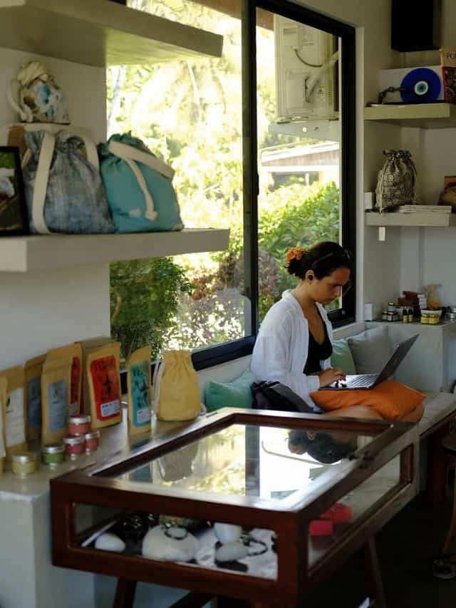 Traveller working on a laptop in the indoor co-working space at Mellow Hostel Ahangama.